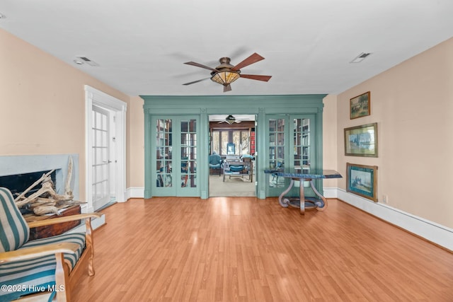 unfurnished room featuring french doors and light wood-type flooring