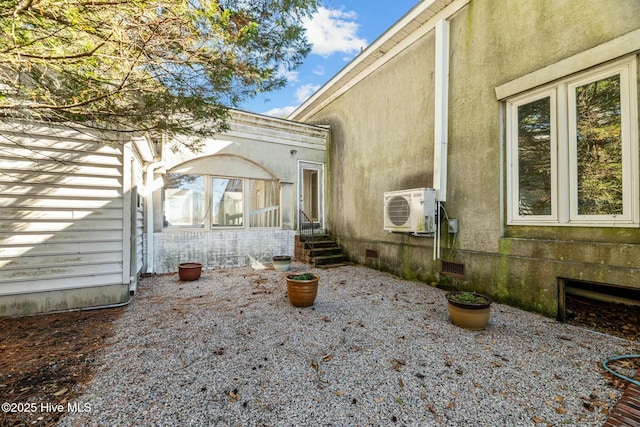 exterior space with ac unit and a patio