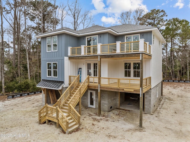 rear view of house with a balcony and french doors