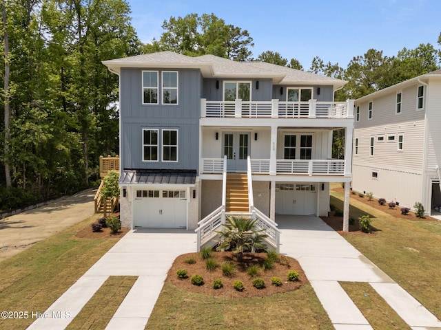 629 Vale Dr, Wilmington, NC 28411 - raised beach house featuring stairway, french doors, and board and batten siding