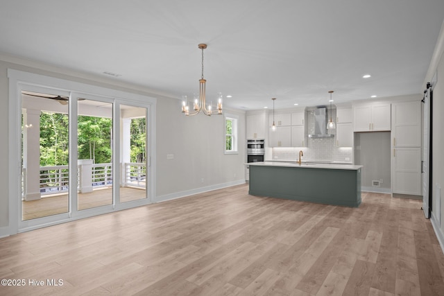 629 Vale Dr, Wilmington, NC 28411 - unfurnished living room with a sink, light wood-type flooring, a chandelier, recessed lighting, and baseboards