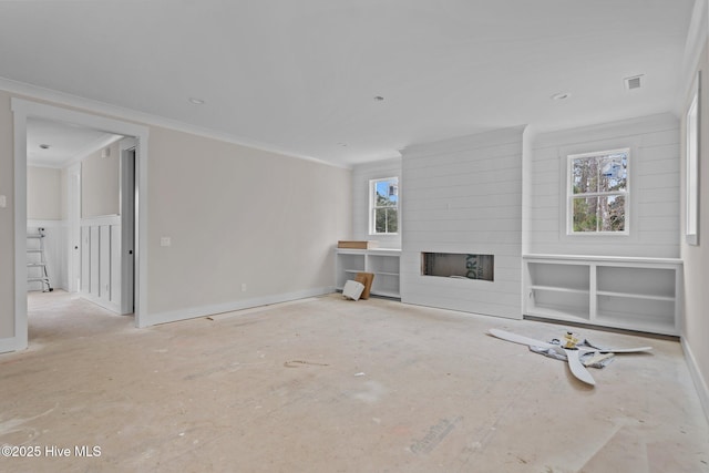 unfurnished living room with ornamental molding, baseboards, and a fireplace