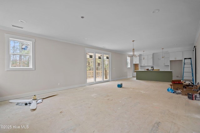unfurnished living room with baseboards, visible vents, and ornamental molding
