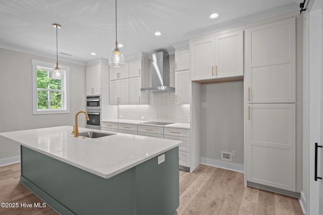 629 Vale Dr, Wilmington, NC 28411 - kitchen with wall chimney exhaust hood, black electric stovetop, a sink, baseboards, and white cabinetry