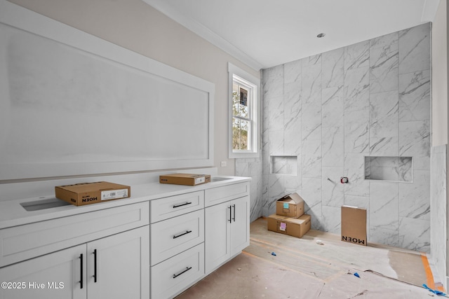 bathroom with tile walls and crown molding