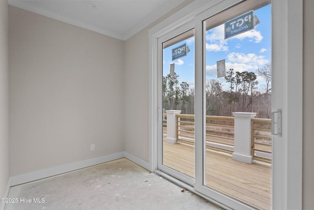 entryway featuring ornamental molding and concrete floors