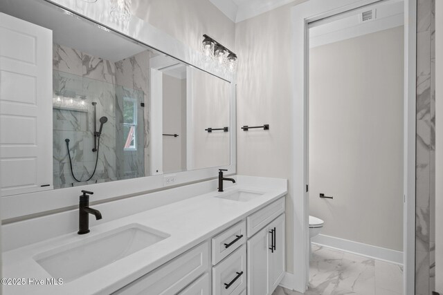 629 Vale Dr, Wilmington, NC 28411 - full bath with marble look tiles, a marble finish shower, baseboards, toilet, and double vanity