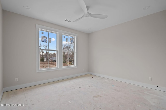 spare room with visible vents, ceiling fan, and baseboards