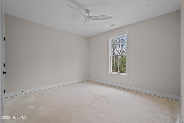 spare room with visible vents, a ceiling fan, and baseboards