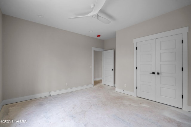 unfurnished bedroom featuring a closet, a ceiling fan, unfinished concrete flooring, and baseboards