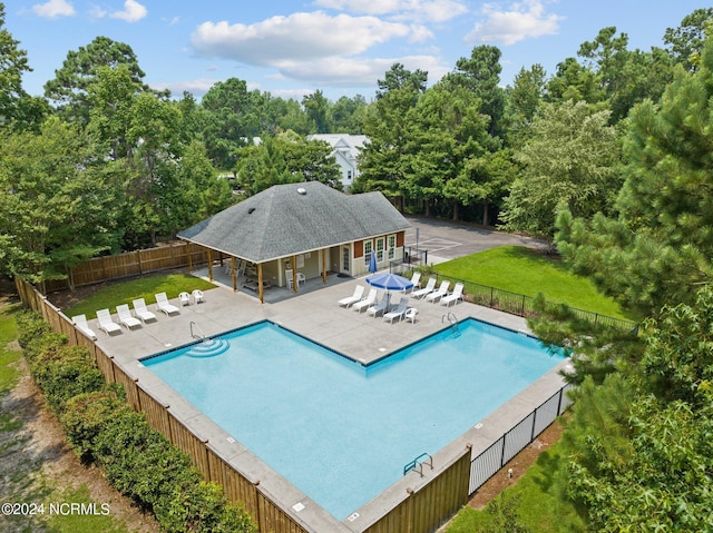 view of swimming pool featuring a lawn and a patio