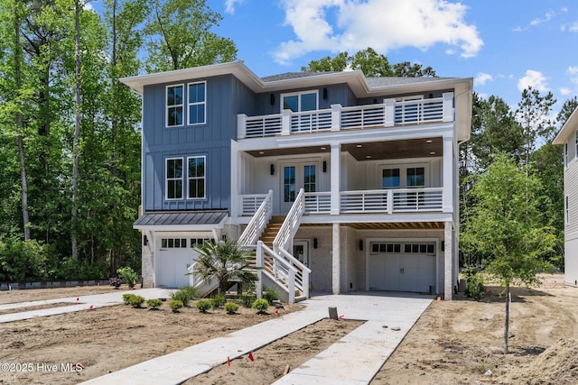 raised beach house with board and batten siding, stairway, french doors, and a balcony
