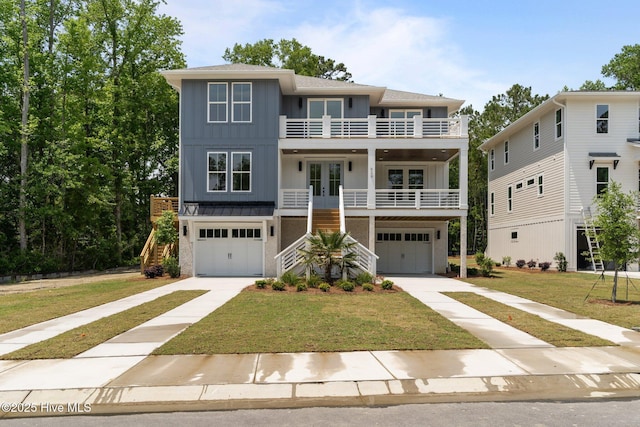 629 Vale Dr, Wilmington, NC 28411 - coastal inspired home featuring french doors, a balcony, stairs, board and batten siding, and a garage