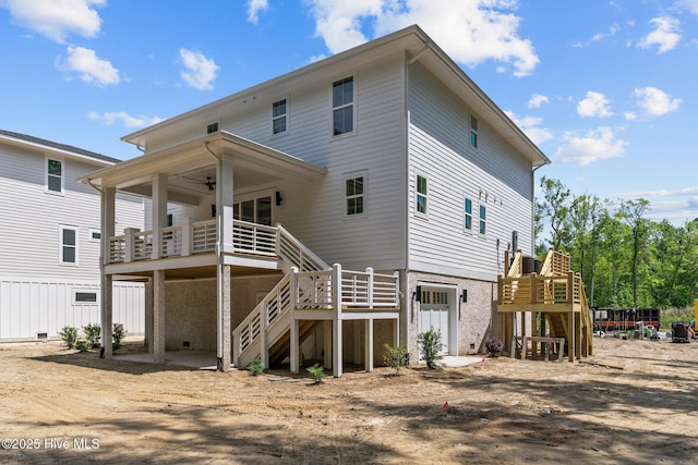 rear view of property with a ceiling fan and stairway