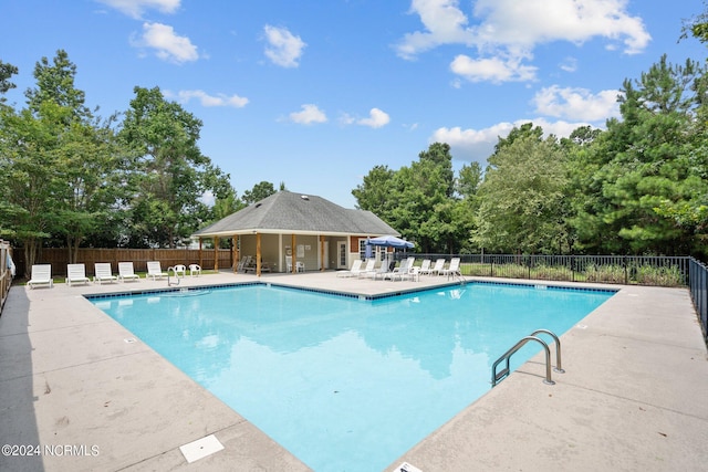pool featuring a patio and fence