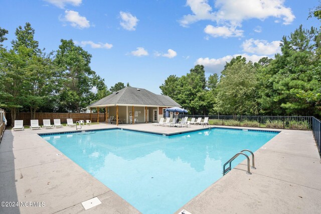 629 Vale Dr, Wilmington, NC 28411 - community pool with a patio and view of scattered trees