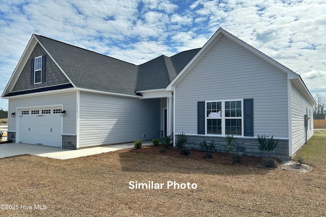 view of front of property featuring a garage and a front lawn