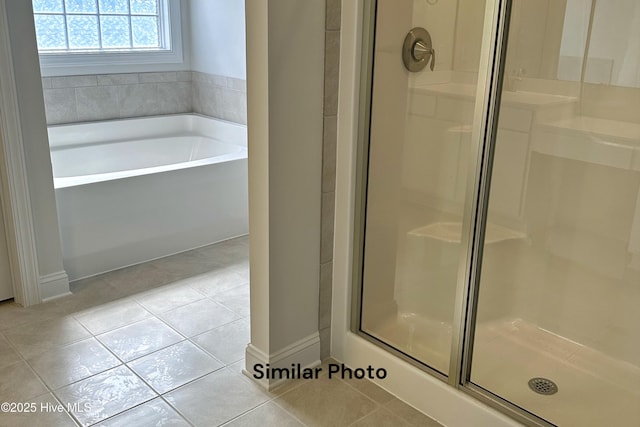 bathroom featuring tile patterned floors and plus walk in shower