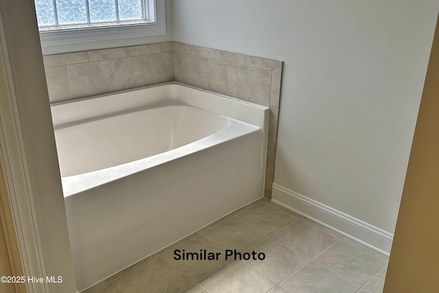 bathroom featuring tile patterned flooring and a washtub