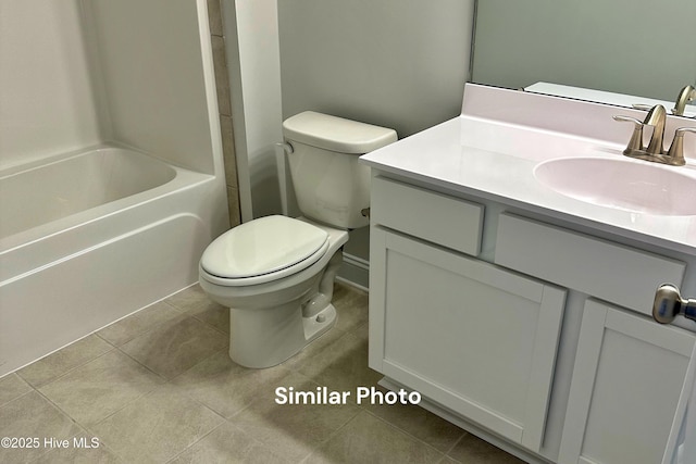 full bathroom with tile patterned floors, vanity, shower / bath combination, and toilet