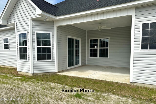 exterior space featuring a patio area, ceiling fan, and a yard