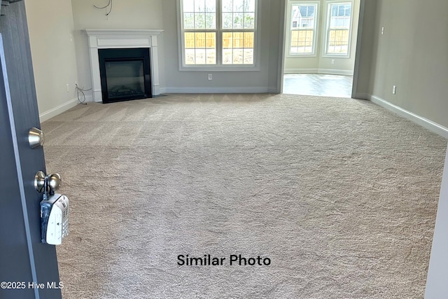 unfurnished living room featuring carpet