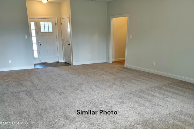 view of carpeted foyer entrance