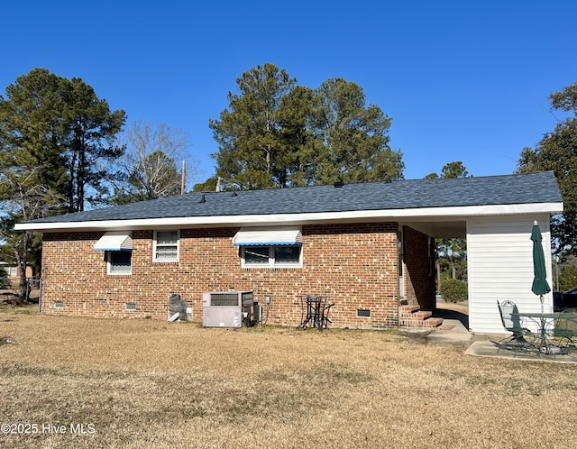 rear view of property with a lawn, cooling unit, and a patio