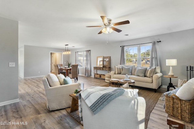 living room featuring ceiling fan and wood-type flooring