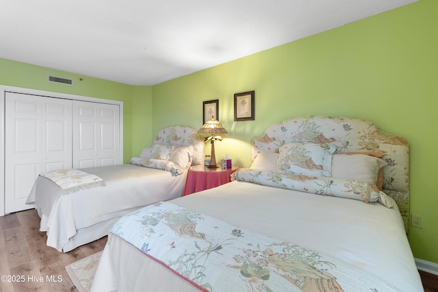 bedroom with a closet and hardwood / wood-style flooring