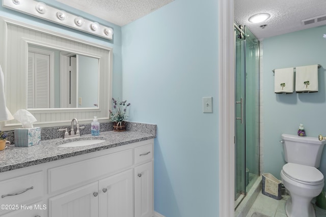 bathroom featuring a textured ceiling, walk in shower, vanity, and toilet