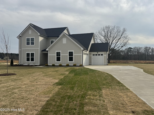 traditional-style home with board and batten siding, a front yard, a garage, and driveway