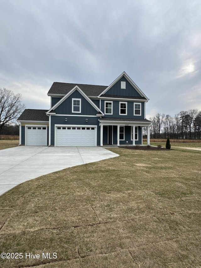 4158 Dixon Rd, Grimesland, NC 27837 - view of front of house featuring an attached garage, a porch, concrete driveway, and a front lawn