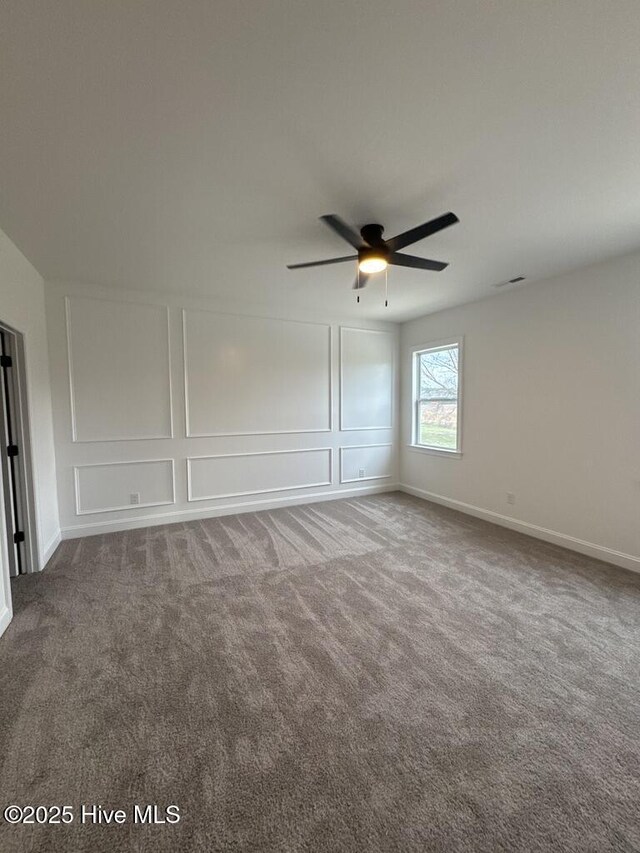 4158 Dixon Rd, Grimesland, NC 27837 - spare room featuring visible vents, ceiling fan, baseboards, carpet, and a decorative wall