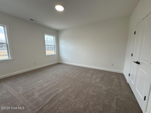 4158 Dixon Rd, Grimesland, NC 27837 - spare room featuring visible vents, carpet floors, ceiling fan, and a decorative wall