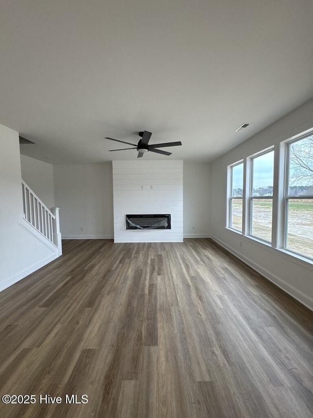4158 Dixon Rd, Grimesland, NC 27837 - unfurnished living room with a ceiling fan, visible vents, dark wood-style flooring, and baseboards
