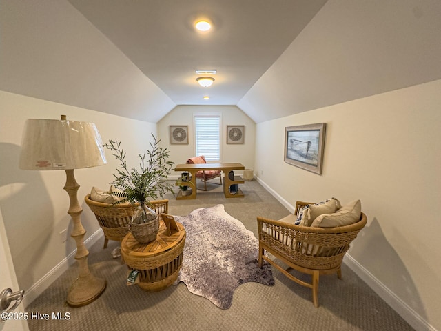 sitting room featuring carpet flooring and lofted ceiling