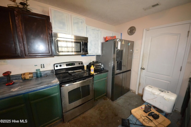 kitchen featuring dark brown cabinetry and stainless steel appliances