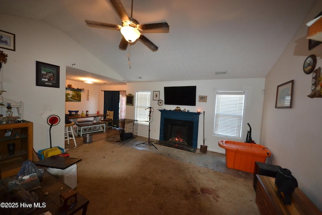 carpeted living room featuring ceiling fan and lofted ceiling