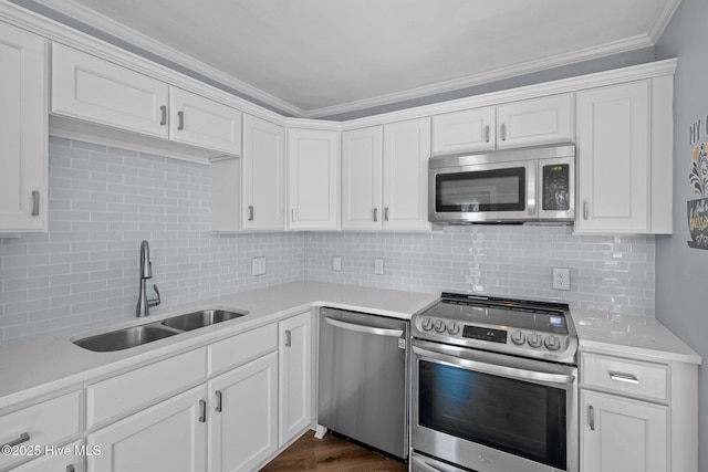 kitchen with appliances with stainless steel finishes, light countertops, and a sink