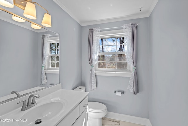 bathroom with marble finish floor, ornamental molding, toilet, and baseboards