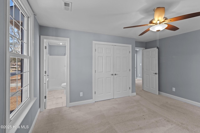 unfurnished bedroom with carpet, visible vents, baseboards, and a closet