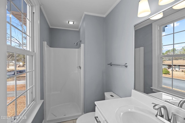 bathroom featuring toilet, a shower, crown molding, and vanity