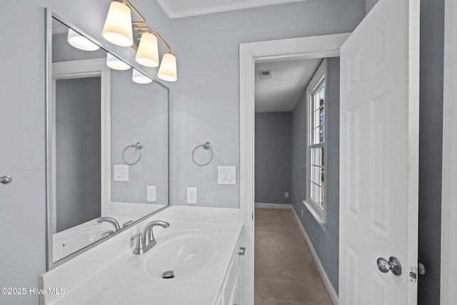 bathroom with baseboards, visible vents, ornamental molding, and vanity