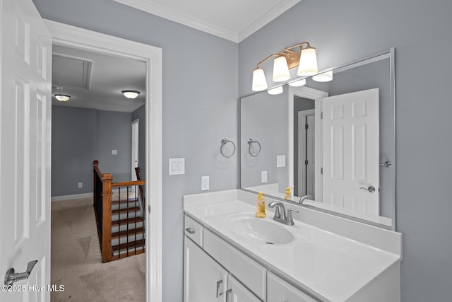 bathroom with ornamental molding, vanity, and baseboards