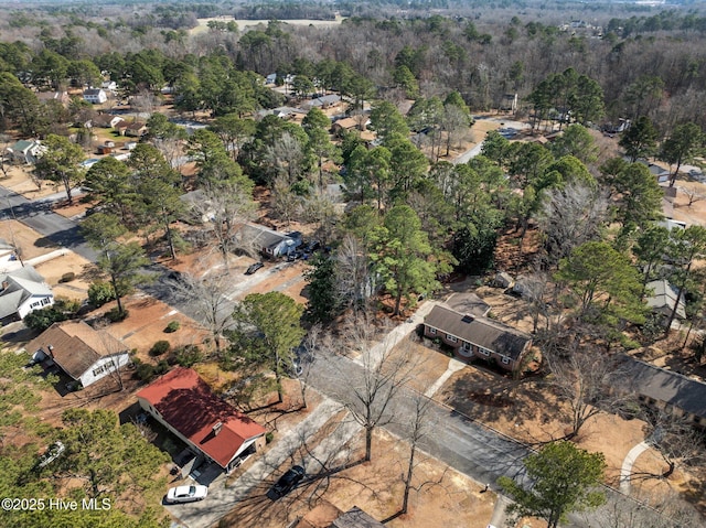 birds eye view of property featuring a wooded view