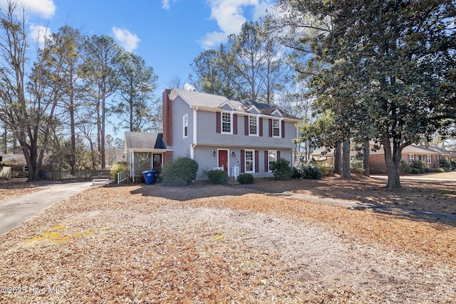 colonial home with fence