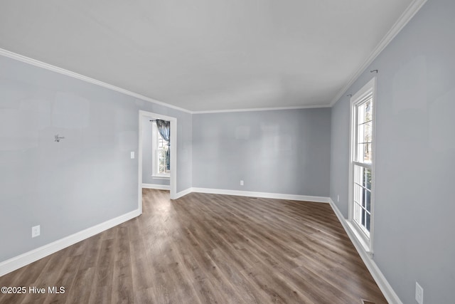 unfurnished room with ornamental molding, baseboards, and wood finished floors