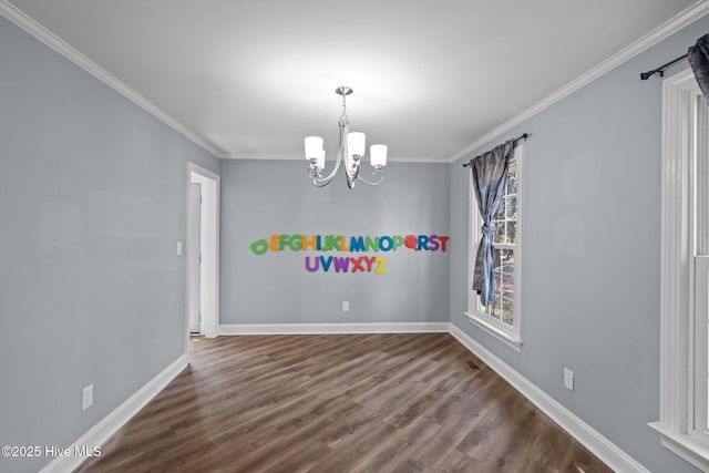 unfurnished room with a notable chandelier, dark wood-style flooring, visible vents, baseboards, and ornamental molding