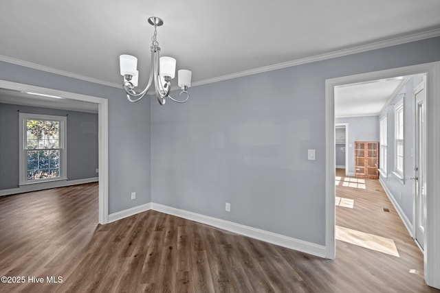 unfurnished dining area featuring ornamental molding, a wealth of natural light, and baseboards